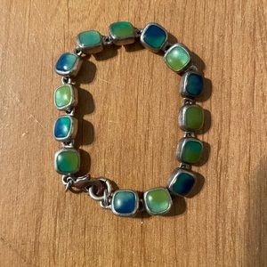 Pretty bracelet with deep green/blue colored stones. Good condition!